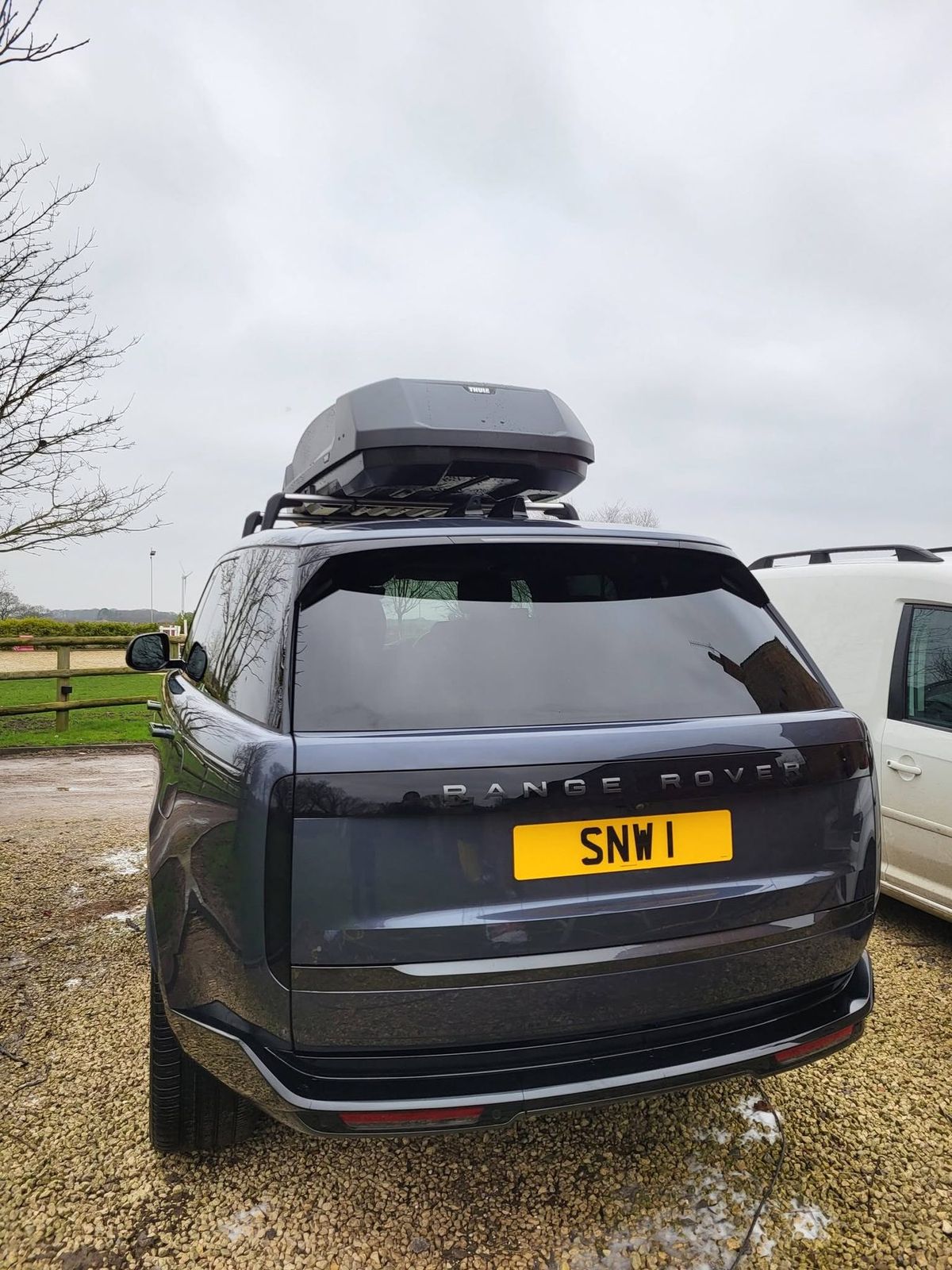 Rear of the same four-wheel drive after valeting, tailgate and glass clean and reflecting the sky